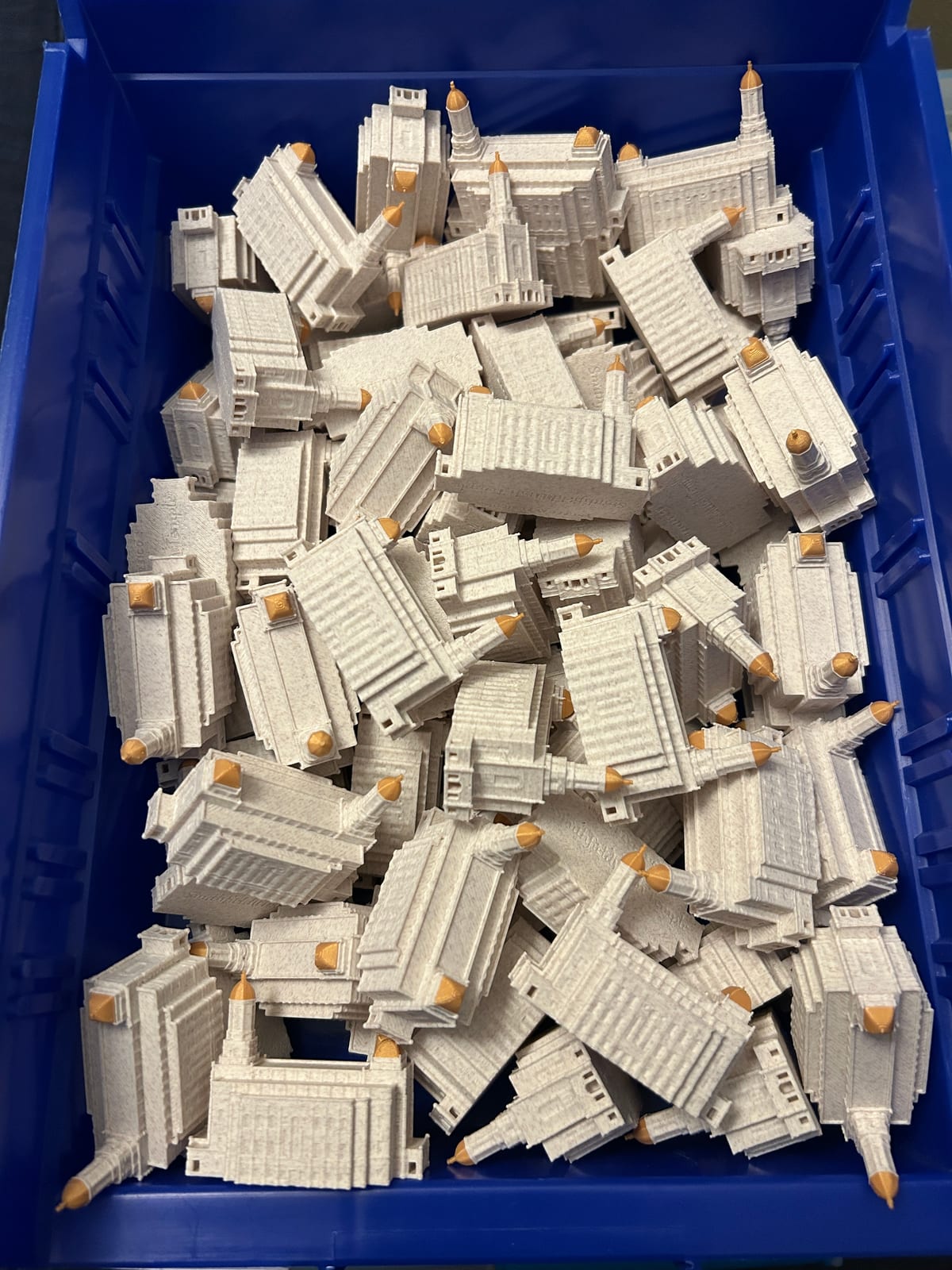 A bin full of tiny 2in Smithfield Utah Temple statues, a bulk batch ready for a ward or stake activity